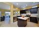 Open kitchen with stainless steel appliances, a center island, and a view to the patio at 1908 Oliver Springs St, Henderson, NV 89052