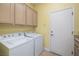 Laundry room has a washer, dryer, and lots of storage in overhead cabinets at 1908 Oliver Springs St, Henderson, NV 89052