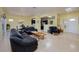 Open-concept living room with tile flooring, neutral paint, dining area, and views to the kitchen at 1908 Oliver Springs St, Henderson, NV 89052