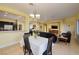 Open-concept living room features a dining area with stylish chandelier and black leather sofas at 1908 Oliver Springs St, Henderson, NV 89052