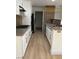 Galley kitchen boasts white cabinets, stainless steel appliances, and granite countertops at 2200 S Fort Apache Rd # 2123, Las Vegas, NV 89117