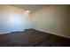 Living room with dark wood-look floors and two doors to other areas at 231 W Horizon Ridge Pkwy # 314, Henderson, NV 89012