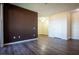 Living room with an accent wall and dark wood-look floors and an entry door at 231 W Horizon Ridge Pkwy # 314, Henderson, NV 89012
