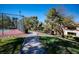Outdoor tennis court with trees, landscaping, and a paved walkway leading to condos at 231 W Horizon Ridge Pkwy # 314, Henderson, NV 89012