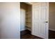 Walk-in closet with an open door and built-in shelves and wood-look floor at 231 W Horizon Ridge Pkwy # 314, Henderson, NV 89012