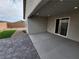 Covered patio and paved backyard with small patch of turf at 247 Desoto Falls St, Indian Springs, NV 89018