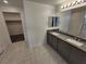 Bathroom with double sink vanity, granite countertop and tiled flooring at 247 Desoto Falls St, Indian Springs, NV 89018
