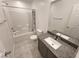 This primary bathroom has a granite countertop and tub with shower at 247 Desoto Falls St, Indian Springs, NV 89018