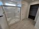 Bathroom featuring glass enclosed shower with seat and tile flooring at 247 Desoto Falls St, Indian Springs, NV 89018