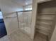 Bathroom with glass enclosed shower with seat and built-in shelving at 247 Desoto Falls St, Indian Springs, NV 89018