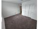 Carpeted bedroom with closet and ensuite bathroom entrance at 247 Desoto Falls St, Indian Springs, NV 89018