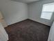 Clean and bright bedroom with neutral carpet, a window, and a fresh coat of white paint at 247 Desoto Falls St, Indian Springs, NV 89018