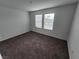 Neutral bedroom with carpet and two windows with blinds at 247 Desoto Falls St, Indian Springs, NV 89018