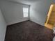 This carpeted bedroom has a bright window and an ensuite bathroom at 247 Desoto Falls St, Indian Springs, NV 89018