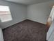 Neutral carpeted bedroom with a window and an ensuite entrance at 247 Desoto Falls St, Indian Springs, NV 89018