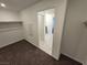Walk-in closet with carpet, rod for hanging clothes, and an electrical box at 247 Desoto Falls St, Indian Springs, NV 89018