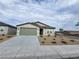 Charming single-story home featuring desert landscaping, a two-car garage and a welcoming entryway at 247 Desoto Falls St, Indian Springs, NV 89018
