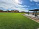 Expansive community green space with picnic area and new home construction in the background at 247 Desoto Falls St, Indian Springs, NV 89018