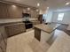Well-lit kitchen featuring granite countertops, stainless steel appliances and a center island with a sink at 247 Desoto Falls St, Indian Springs, NV 89018