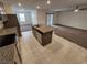 Open kitchen featuring stainless steel appliances, granite countertops and center island adjacent to living area at 247 Desoto Falls St, Indian Springs, NV 89018