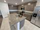 Modern kitchen with granite countertops, stainless steel appliances and center island for food preparation at 247 Desoto Falls St, Indian Springs, NV 89018