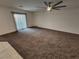 Living room with sliding glass door leading to outside and ceiling fan at 247 Desoto Falls St, Indian Springs, NV 89018