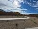 Community sidewalk amidst desert landscaping with young plants and privacy walls at 247 Desoto Falls St, Indian Springs, NV 89018
