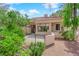 A private back patio offers mature desert landscaping and decorative iron fencing at 2714 Bridgepointe Dr, Las Vegas, NV 89121