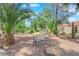 Lush desert landscaping surrounds a shaded outdoor seating area at 2714 Bridgepointe Dr, Las Vegas, NV 89121
