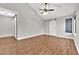 Spacious bedroom featuring hardwood floors, a ceiling fan, and dual barn doors at 2714 Bridgepointe Dr, Las Vegas, NV 89121