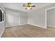 Spacious bedroom with neutral carpet and walls, large window, and sliding closet doors at 2714 Bridgepointe Dr, Las Vegas, NV 89121