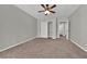 Neutral bedroom features plush carpeting, ceiling fan, and closet with sliding doors at 2714 Bridgepointe Dr, Las Vegas, NV 89121