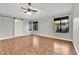 Bedroom featuring hardwood floors, windows with views, ceiling fan, and barn door closet at 2714 Bridgepointe Dr, Las Vegas, NV 89121