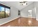 Bedroom with vaulted ceiling, hardwood floors, ceiling fan, and large windows at 2714 Bridgepointe Dr, Las Vegas, NV 89121
