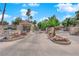 Gated community entrance features manicured landscaping, desert flowers and palm trees at 2714 Bridgepointe Dr, Las Vegas, NV 89121