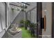 Staged patio with wicker furniture and potted plants at 2714 Bridgepointe Dr, Las Vegas, NV 89121