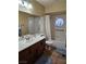 Neutral bathroom featuring a large mirror, a single sink vanity, and a shower-tub combination with tiled surround at 2750 Sandalwood Ave, Henderson, NV 89074