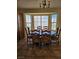 Sunlit dining area with a large window, tile flooring, and a stylish chandelier at 2750 Sandalwood Ave, Henderson, NV 89074