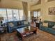 Cozy living room with plush sofas, a decorative rug, and bright natural light from large windows at 2750 Sandalwood Ave, Henderson, NV 89074