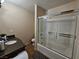 Bathroom showcasing a shower-tub combo with a glass enclosure and a vanity with granite counters at 3145 E Flamingo Rd # 2005, Las Vegas, NV 89121
