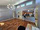 Open floor plan with hardwood floors, vaulted ceiling, modern light fixture, and open access to kitchen at 3145 E Flamingo Rd # 2005, Las Vegas, NV 89121
