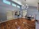 Open floor plan with hardwood floors, vaulted ceiling, modern light fixture, and pass through to kitchen at 3145 E Flamingo Rd # 2005, Las Vegas, NV 89121