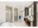 Sleek bathroom boasting dual vanities, a modern soaking tub, and glass-enclosed shower at 3750 Las Vegas Blvd # 3008, Las Vegas, NV 89158