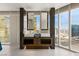 Modern bathroom with dual sinks, vanity, and large windows offering beautiful views of the city skyline at 3750 Las Vegas Blvd # 3008, Las Vegas, NV 89158