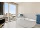 Modern bathroom featuring a soaking tub and floor-to-ceiling windows with spectacular cityscape views at 3750 Las Vegas Blvd # 3008, Las Vegas, NV 89158