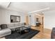 Open-concept living area with hardwood floors, large windows, a sectional sofa, and recessed lighting at 3750 Las Vegas Blvd # 3008, Las Vegas, NV 89158