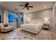 Serene bedroom with soft natural light, neutral tones, and a comfortable armchair at 379 Fynn Valley Dr, Las Vegas, NV 89148