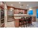 Well-equipped kitchen with a large island, granite countertops, and stainless steel appliances at 379 Fynn Valley Dr, Las Vegas, NV 89148
