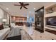 Open living space with a fireplace, seamless flow to the kitchen, and modern tile flooring at 379 Fynn Valley Dr, Las Vegas, NV 89148