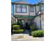 Charming two-story townhouse with pink exterior, green trim, a landscaped front yard, and a welcoming front porch at 4037 Chalfont Ct, Las Vegas, NV 89121